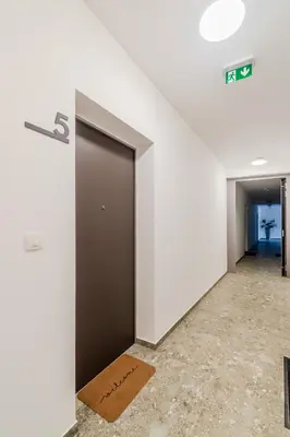 a hallway with a door with a sign on it at Apartment Hajdi with Sauna & Garage in Bovec