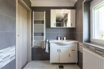 a bathroom with a white sink and a mirror at Apartma Majdas in Loka pri Mengšu