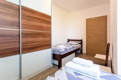 a small room with a bed and a closet at Apartma Majdas in Loka pri Mengšu