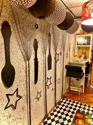 a wall with spoons and stars on it at Centralish Dragon Heart Ljubljana in Ljubljana