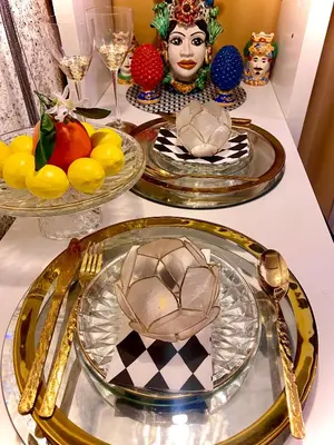 a table with plates of food and a statue of a woman at Centralish Dragon Heart Ljubljana in Ljubljana