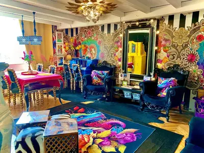 a living room with chairs and a table and a mirror at Centralish Dragon Heart Ljubljana in Ljubljana