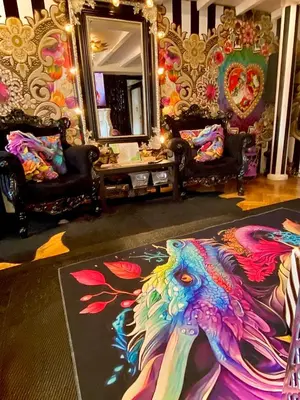a room with two chairs and a painting of a peacock at Centralish Dragon Heart Ljubljana in Ljubljana