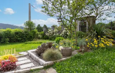 a garden with flowers and plants in a yard at 1 Bedroom Beautiful Apartment In Divaca in Divača