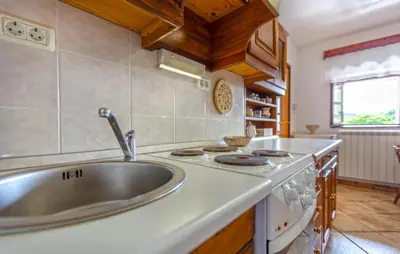 a kitchen with a sink and a stove at 1 Bedroom Beautiful Apartment In Divaca in Divača