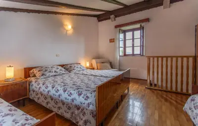 a bedroom with a large bed and a window at 1 Bedroom Beautiful Apartment In Divaca in Divača