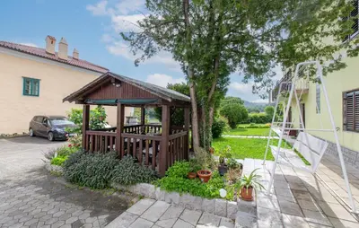 a wooden gazebo in the backyard of a house at 1 Bedroom Beautiful Apartment In Divaca in Divača