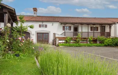 a white house with a porch and a yard at 1 Bedroom Beautiful Apartment In Divaca in Divača