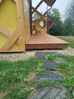 a porch of a house with a wooden deck at Apartments Kr'Bee in Mala Nedelja
