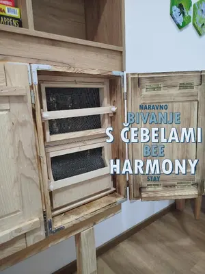 a wooden cabinet with a window in a room at Apartments Kr'Bee in Mala Nedelja