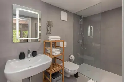 a bathroom with a sink and a toilet and a shower at Aroma apartments in Ljubljana