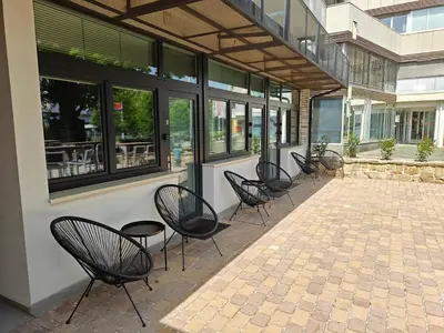 a group of chairs sitting outside of a building at Aroma apartments in Ljubljana
