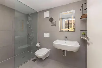a bathroom with a toilet and a sink and a shower at Aroma apartments in Ljubljana