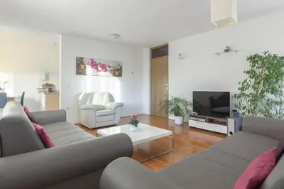 a living room with two couches and a tv at Fine Stay Apartments in Žirovnica