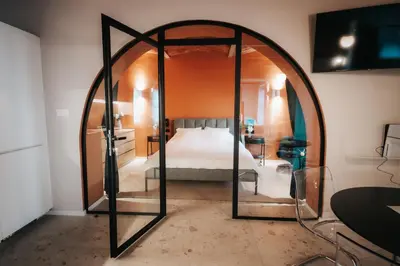 a bedroom with a bed and an arched doorway at Luxury Residence Metlika in Metlika