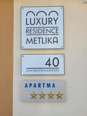 a sign for a latiny residence in mexico at Luxury Residence Metlika in Metlika