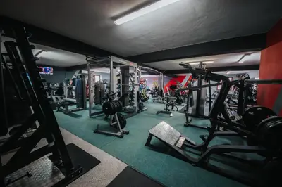 a gym with several treadmills and machines at Luxury Residence Metlika in Metlika