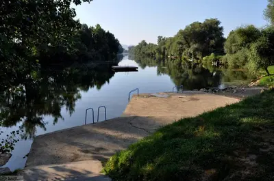 a view of a river with a boat in it at Luxury Residence Metlika in Metlika