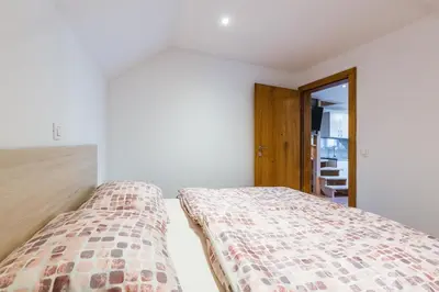 a bedroom with two beds in a room at Pogacar Apartments in Bled
