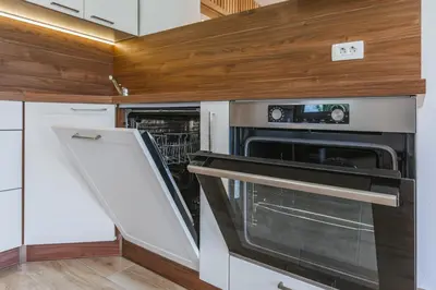 a kitchen with an oven and a dishwasher at Pogacar Apartments in Bled