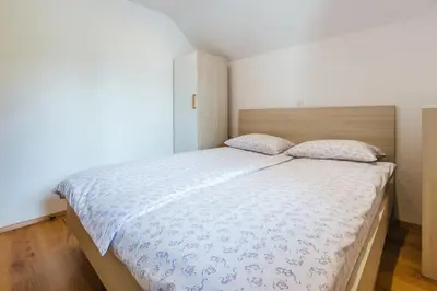 a bedroom with a large bed in a room at Pogacar Apartments in Bled