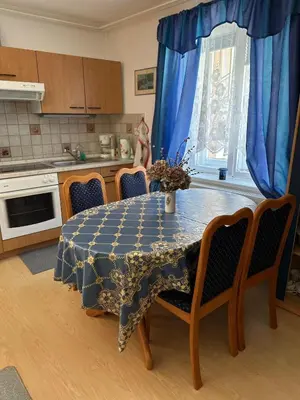 a kitchen with a table with a blue table cloth on it at Apartma Mimi in Bovec