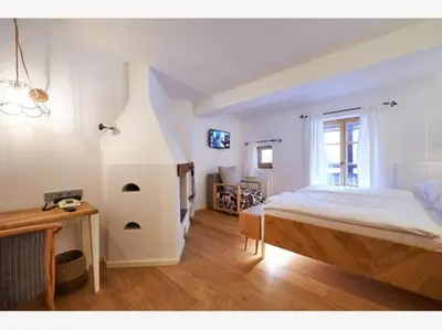 a bedroom with a bed and a desk in a room at Villa Palenk Logar Valley in Solčava