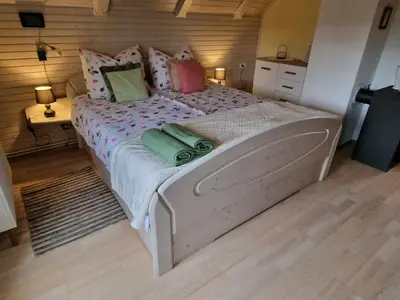a bedroom with a large bed with colorful pillows at House 29 in Begunje na Gorenjskem