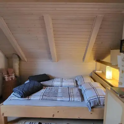 a bed with two pillows in a room at House 29 in Begunje na Gorenjskem
