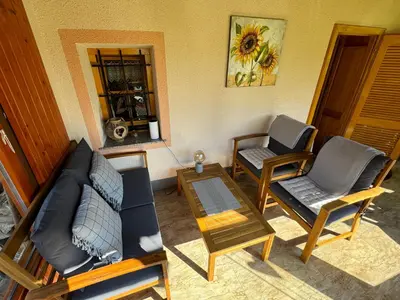 a living room with a couch and two chairs at House 29 in Begunje na Gorenjskem
