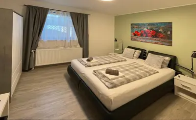 a bedroom with a bed and a window at Roses Apartment Prijeten apartma za dve osebi in Mengeš