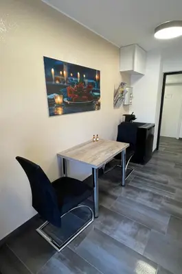 a dining room with a table and a chair at Roses Apartment Prijeten apartma za dve osebi in Mengeš