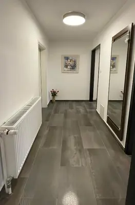 a hallway with white walls and a mirror and a hallway with a hallway at Roses Apartment Prijeten apartma za dve osebi in Mengeš