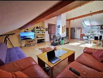 a living room with a couch and a table with a laptop at Morning sunshine in Bled
