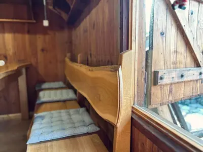 a row of seats in a train car at Somova gora chalet in the woods in Kočevje