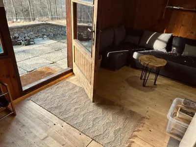 a living room with a couch and a table at Somova gora chalet in the woods in Kočevje