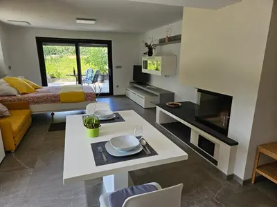 a living room with a bed and a table with plates on it at Red Riding Hood in Ljubljana