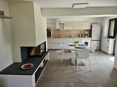 a kitchen with a fireplace and a table and chairs at Red Riding Hood in Ljubljana