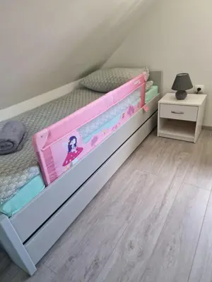 a childs bedroom with a pink and white bunk bed at Hiška 111 s kopalnimi kartami in Brežice