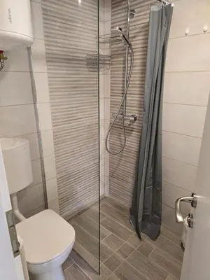 a bathroom with a shower and a toilet at Hiška 111 s kopalnimi kartami in Brežice