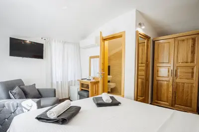 a hotel room with a bed and a couch at Hotel Šiška in Ljubljana