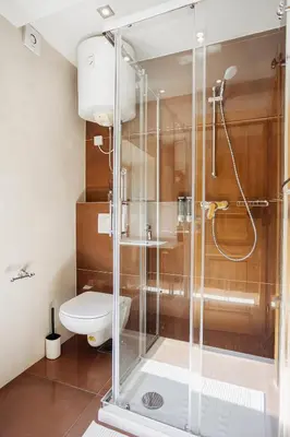 a bathroom with a glass shower with a toilet at Hotel Šiška in Ljubljana