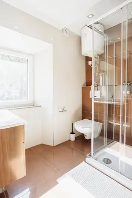 a bathroom with a glass shower and a toilet at Hotel Šiška in Ljubljana