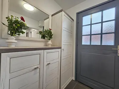 a bathroom with white cabinets and a door and a window at Zeleni Biser -Terme Čatež in Čatež ob Savi