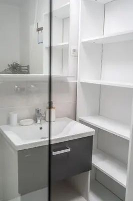 a white bathroom with a sink and a mirror at Apartment Swim and Relax in Moravske Toplice