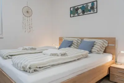 a bed with two towels on top of it at Apartment Swim and Relax in Moravske Toplice