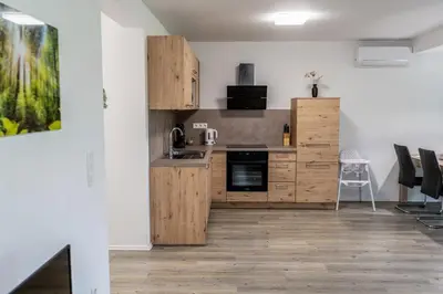 a kitchen with wooden cabinets and a counter top at Apartment Swim and Relax in Moravske Toplice