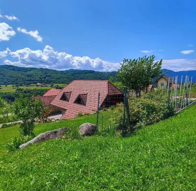 a house with a red roof on a green field at Holiday home in Dolenjske Toplice - Kranjska (Krain) 51092 in Dolenjske Toplice