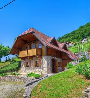 a wooden house with a balcony on a hill at Holiday home in Dolenjske Toplice - Kranjska (Krain) 51092 in Dolenjske Toplice