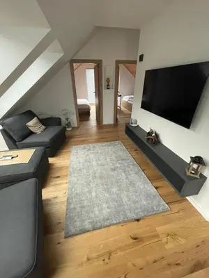 a living room with a couch and a flat screen tv at Walter Apartments in Gozd Martuljek